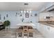 Open-concept dining area with stylish table and chairs, adjacent to the kitchen at 2222 Ocean Shore Blvd # 304B, Ormond Beach, FL 32176