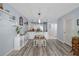 Cozy dining area open to the kitchen with white cabinets and laminate flooring at 2222 Ocean Shore Blvd # 304B, Ormond Beach, FL 32176