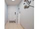Bright entryway featuring decorative wall art, shoe cabinet, and tiled flooring at 2222 Ocean Shore Blvd # 304B, Ormond Beach, FL 32176