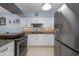 Modern kitchen with stainless steel appliances, granite countertops, and white cabinetry at 2222 Ocean Shore Blvd # 304B, Ormond Beach, FL 32176