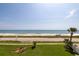 Expansive ocean view from property overlooking beach, road and manicured lawn at 2222 Ocean Shore Blvd # 304B, Ormond Beach, FL 32176
