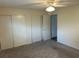 Bedroom with neutral walls, carpet, and closet with sliding doors, offering ample storage at 233 Elmwood Ave # 290, Deland, FL 32724
