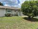 Charming single-story home with a well-maintained lawn and flowering shrubs in a sunny neighborhood at 233 Elmwood Ave # 290, Deland, FL 32724