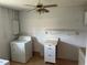 This laundry room features a washer, dryer, and storage cabinets at 233 Elmwood Ave # 290, Deland, FL 32724