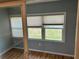 Neutral living room with wood floors and sliding glass door to back yard at 233 Elmwood Ave # 290, Deland, FL 32724