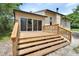Exterior view of the deck with wooden steps and glass sliding doors at 241 Bayou Vista St, Debary, FL 32713