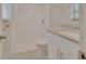 Bathroom with white shower/tub combo, sink with granite countertop and white cabinet storage at 241 Bayou Vista St, Debary, FL 32713