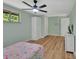 Light-filled bedroom with wood floors, ceiling fan, and exterior view window at 241 Bayou Vista St, Debary, FL 32713