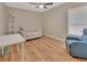 Cozy bedroom with neutral tones, wood floors, and comfortable seating area at 241 Bayou Vista St, Debary, FL 32713