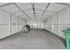 Spacious garage interior with concrete floor, shelving, and motorcycle at 241 Bayou Vista St, Debary, FL 32713