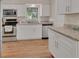 An additional shot of the kitchen with white cabinetry and granite countertops with stainless steel appliances at 241 Bayou Vista St, Debary, FL 32713