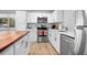 Well-equipped kitchen featuring stainless steel appliances, white cabinets, and a stylish countertop at 2434 Barbarossa Ave, Deltona, FL 32738