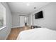 Stylish bedroom featuring a modern barn door, TV, and wood laminate flooring at 2434 Barbarossa Ave, Deltona, FL 32738