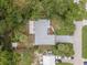 Birds-eye view of the property, showcasing the home's layout, roof, and surrounding trees at 2509 Kumquat Dr, Edgewater, FL 32141