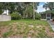 View of the backyard showing lawn, shed for storage, and an enclosed porch at 2509 Kumquat Dr, Edgewater, FL 32141