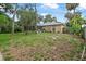 Expansive backyard featuring lush greenery, mature trees, and a well-maintained lawn at 2509 Kumquat Dr, Edgewater, FL 32141