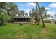 Spacious backyard with a screened porch, perfect for outdoor entertaining and relaxation at 2509 Kumquat Dr, Edgewater, FL 32141