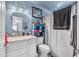 Bright bathroom featuring a vanity with sink, a decorative mirror, and a shower with curtain at 2509 Kumquat Dr, Edgewater, FL 32141
