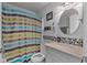 Modern bathroom with stylish fixtures, a colorful shower curtain, and a clean design at 2509 Kumquat Dr, Edgewater, FL 32141