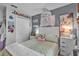Charming bedroom featuring a comfortable bed, playful decor, and stylish furnishings at 2509 Kumquat Dr, Edgewater, FL 32141