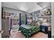 Colorful bedroom featuring playful decor, a comfortable bed, and functional furnishings at 2509 Kumquat Dr, Edgewater, FL 32141