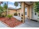 Cozy front patio space with decorative landscaping and covered entry way at 2509 Kumquat Dr, Edgewater, FL 32141