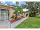 Inviting entrance with a well-manicured lawn and landscaping leading to the front door at 2509 Kumquat Dr, Edgewater, FL 32141