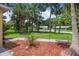 Charming home featuring a lush front yard, mature trees, and meticulous landscaping details at 2509 Kumquat Dr, Edgewater, FL 32141