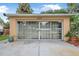 Garage with sliding glass door and ample natural light, perfect for a workshop or hobby space at 2509 Kumquat Dr, Edgewater, FL 32141