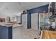 Well-lit kitchen showing stainless steel appliances, tile flooring, and access to other areas of the home at 2509 Kumquat Dr, Edgewater, FL 32141