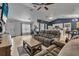 Spacious living room featuring neutral tones, tile floors, and open layout to kitchen at 2509 Kumquat Dr, Edgewater, FL 32141