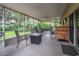 Inviting screened-in patio with outdoor seating, a fire pit, and relaxing ambiance at 2509 Kumquat Dr, Edgewater, FL 32141