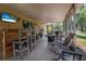 Large screened patio with multiple seating areas and outdoor dining space at 2509 Kumquat Dr, Edgewater, FL 32141