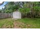 Storage shed in the backyard featuring secure double doors and a well-maintained appearance at 2509 Kumquat Dr, Edgewater, FL 32141