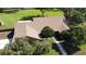 A beautiful aerial view of the home's roof, manicured lawn, mature trees, and proximity to a tranquil pond at 2699 Audubon Ave, Deland, FL 32720