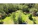 Expansive backyard with lush greenery, trees, and a serene pond, creating a private and tranquil oasis at 2699 Audubon Ave, Deland, FL 32720