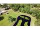 Picturesque pond surrounded by a lush lawn, trees, and a charming shed on this beautiful property at 2699 Audubon Ave, Deland, FL 32720