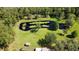 Expansive pond with lush water plants, surrounded by green space, trees, and a quaint shed at 2699 Audubon Ave, Deland, FL 32720
