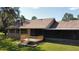 The house features a screened-in back porch and small wooden deck overlooking the well-maintained backyard at 2699 Audubon Ave, Deland, FL 32720