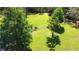 Expansive backyard with a tractor, pond, and lush green grass at 2699 Audubon Ave, Deland, FL 32720