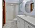 Bright bathroom with a tiled walk-in shower, white vanity, and ample lighting at 2699 Audubon Ave, Deland, FL 32720