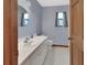 Bathroom featuring an oval mirror, single sink vanity, and light blue walls at 2699 Audubon Ave, Deland, FL 32720