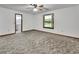 Bedroom features soft carpet, neutral walls, a ceiling fan, and a view of the outdoors at 2699 Audubon Ave, Deland, FL 32720