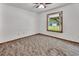Bedroom featuring neutral paint, a ceiling fan, and a large window with a view of the outdoors at 2699 Audubon Ave, Deland, FL 32720