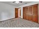 Bedroom featuring wood trim and a closet with paneled doors for ample storage space at 2699 Audubon Ave, Deland, FL 32720