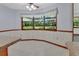 Cozy breakfast nook featuring paneled walls, a ceiling fan, and large windows with a view of the backyard at 2699 Audubon Ave, Deland, FL 32720
