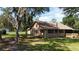 Charming brick home with a well-kept lawn, screened porch and mature trees, providing a serene and inviting atmosphere at 2699 Audubon Ave, Deland, FL 32720