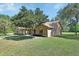 Charming one-story brick home with a well-maintained lawn and mature trees at 2699 Audubon Ave, Deland, FL 32720
