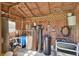Utility building interior with exposed wood construction, water tanks, plumbing, and water filtration system at 2699 Audubon Ave, Deland, FL 32720