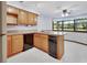 Well-lit kitchen with black appliances, bright wood cabinets, and a central island, complemented by a window at 2699 Audubon Ave, Deland, FL 32720